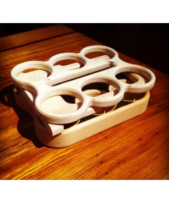 image of flat pack wooden six pack beer carrier on a wooden surface