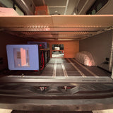 Compact living space inside a vehicle with a bed, and battery system