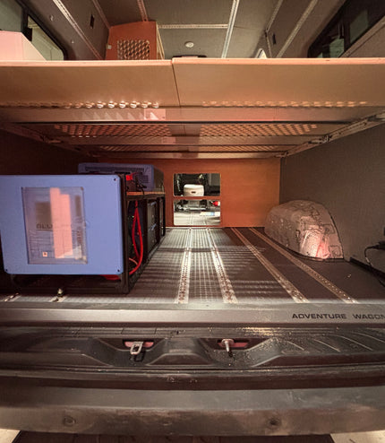 Compact living space inside a vehicle with a bed, and battery system