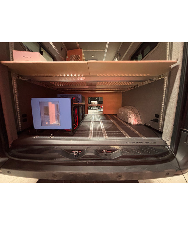 Compact living space inside a vehicle with a bed, and battery system