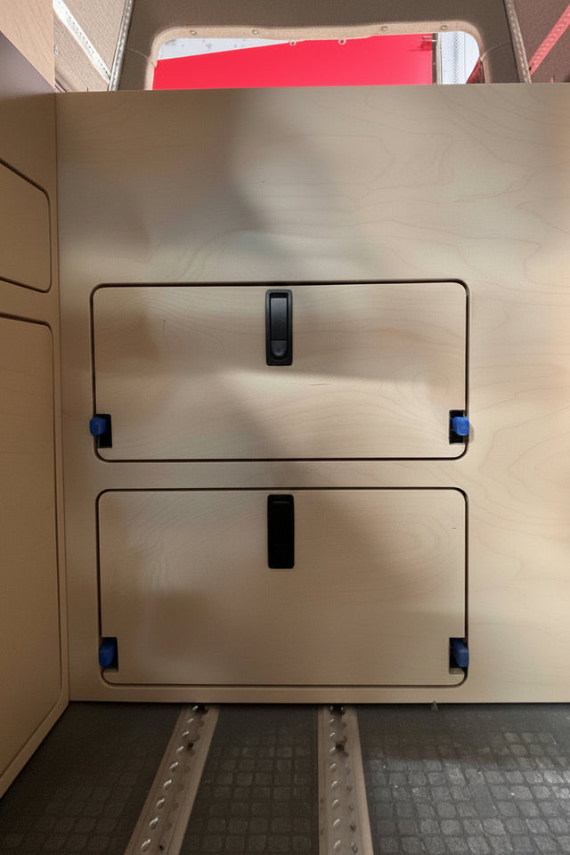 wooden panel with access doors and black rectangular latches surface