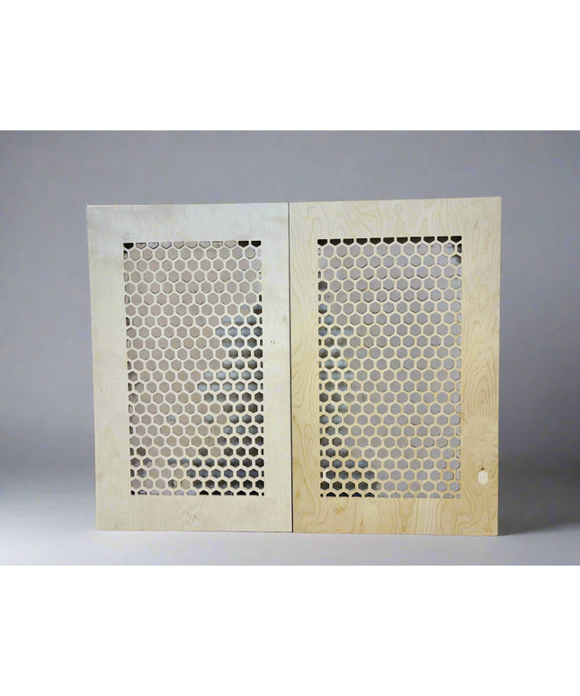 2 plywood boards leaning against a wall with honeycomb pattern on a grey background